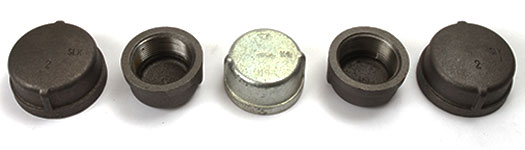 Five types of Galvanized Malleable Iron Caps ranging in size and black and galvanized finishes